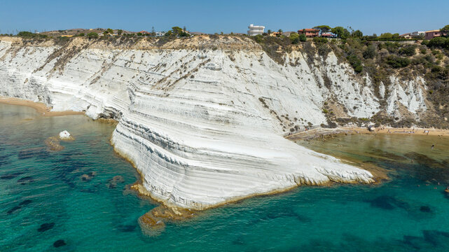 Aerial view of the Scala dei Turchi (Stair of the Turks or Turkish Steps) on the coast of Realmonte, near Agrigento, Sicily, Italy. It's a rocky cliff and tourist attraction. The sea is turquoise.