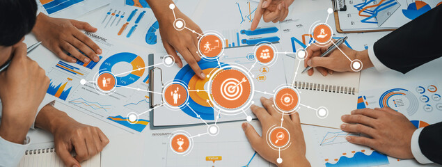 Dynamic workspace showing a collaborative team analyzing charts and graphs to strategize future goals, emphasizing teamwork and innovative solutions for business growth. Amity