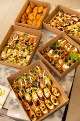 Assorted catering boxes with canapes and pastries for party buffets and delivery