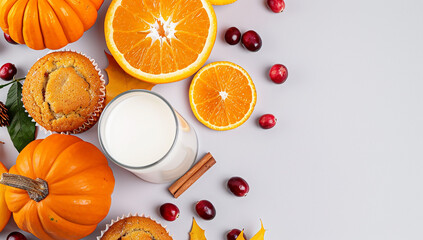 A Vibrant Flat Lay of Delicious Cranberry Muffins Surrounded by Fresh Oranges and a Glass of Milk on a Bright Tabletop