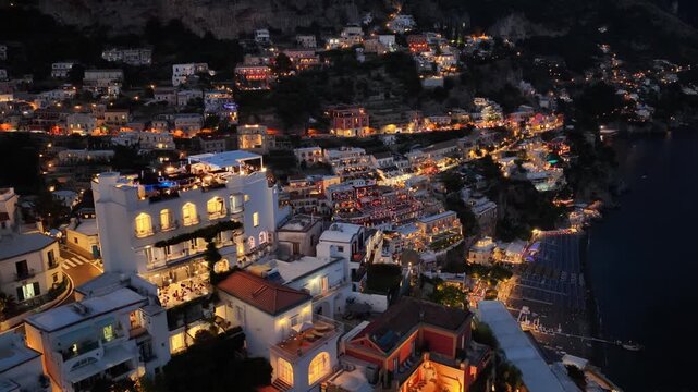 Aerial nighttime view of Positano Italy showing the beautiful coastline and hillside village lit up