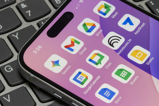 Portland, OR, USA - Nov 11, 2025: Assorted Google Workspace apps are seen on the screen of an iPhone - Gemini, Gmail, Drive, Meet, Calendar, Chat, NotebookLM, AppSheet, Docs, Sheets, and Slides.