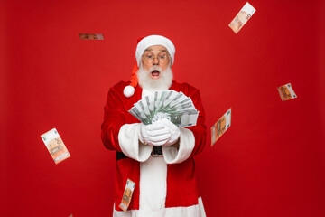 Photo of pensioner old man grey beard raise fists open mouth money shower hold cash wear Santa...