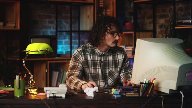 Comic male programmer working on retro computer and winking playfully, 90s style