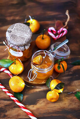 Holiday sweets - tangerines in syrup or  jam or confiture on christmas background