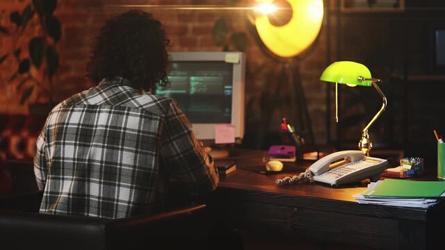 Male programmer facing system error message while coding on retro computer