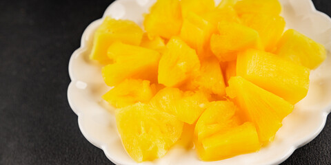 Pineapple canned chunks sweet fruit dessert tasty snack fresh delicious gourmet food background on the table rustic top view copy space keto and paleo diet vegetarian and vegan food