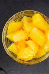 Pineapple canned chunks sweet fruit dessert tasty snack fresh delicious gourmet food background on the table rustic top view copy space keto and paleo diet vegetarian and vegan food