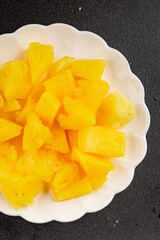 Pineapple canned chunks sweet fruit dessert tasty snack fresh delicious gourmet food background on the table rustic top view copy space keto and paleo diet vegetarian and vegan food