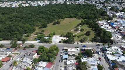 Aerial footage recorded over Mérida, Yucatán, Mexico, showing the intersection between urban and natural zones. The video captures the relationship between city growth and preserved forest area
