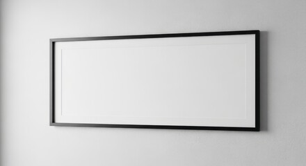 Obraz premium Blank rectangular picture frame with a black border hanging on a textured gray wall, ready for artwork or photos