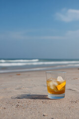 refreshing cocktail with bright fruits and ice in fullsized glass rests on clean soft pastel background