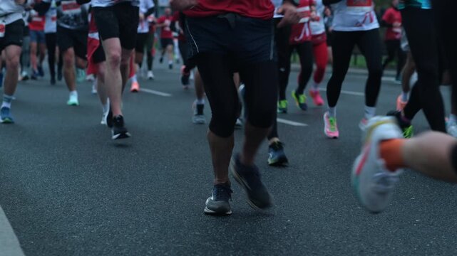 Marathon runner's legs on asphalt road