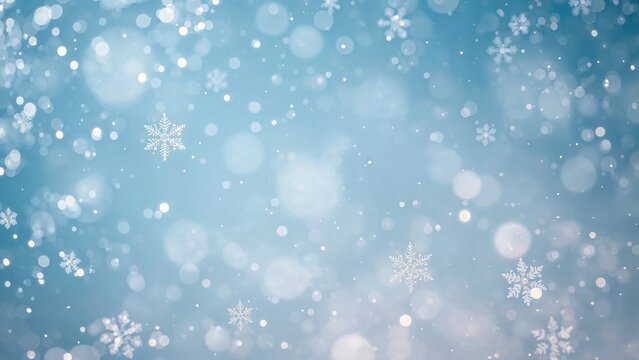 Snowflakes falling against a blue winter sky with bokeh light effects. Winter and holiday theme, cold weather, and festive atmosphere.
