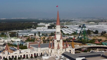Aerial view of theme park with castle and roller coaster