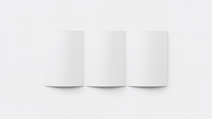 Fototapeta premium Three white folders or papers stand vertically on a white background.