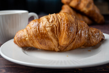 Fresh Croissant with Coffee in Background