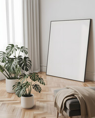 Blank canvas leaning against wall with plants and blanket