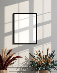 Square mirror on wall with natural light and dried flowers