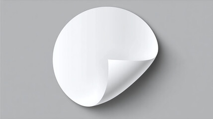 A blank circle sticker with a curled edge. The sticker appears to be floating on the surface