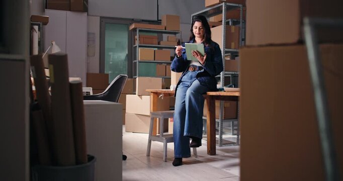 Tablet, startup and woman in office for ecommerce, review or reading email for procurement. Technology, pen and small business entrepreneur with logistics feedback, scroll report or order tracking