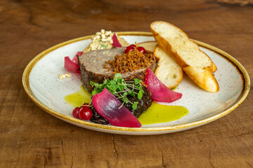 Gourmet meat pâté with pickled onions and toasted bread
