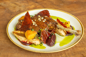 Roasted goose leg with vegetables and microgreens
