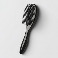 Overhead shot of a black hairbrush with nylon bristles beauty concept