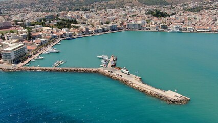 Fototapeta premium Aerial drone view of the main port of Chios, Greece. Ferries, harbor infrastructure, waterfront urban landscape and clear Aegean waters. High-resolution Mediterranean maritime and travel photography.