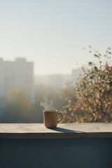 peaceful breakfast scene on balcony overlooking bustling city with solitary cup of coffee