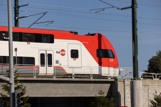 Belmont, California, USA - October 30, 2025: A Caltrain engine pulls away from the downtown Belmont station on a concrete viaduct.