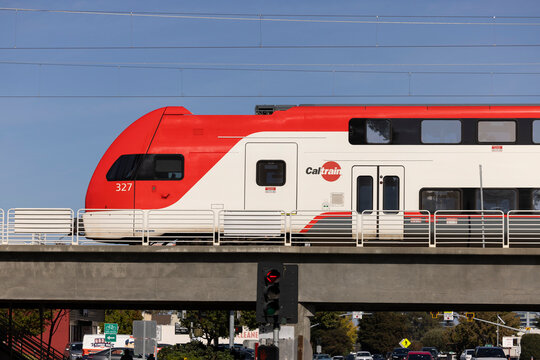 Belmont, California, USA - October 30, 2025: A Caltrain engine pulls away from the downtown Belmont station on a concrete viaduct.