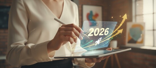 Businesswoman holding a digital tablet and stylus, interacting with a holographic 2026 display showing a rocket launch and rising arrows symbolizing future growth and innovation