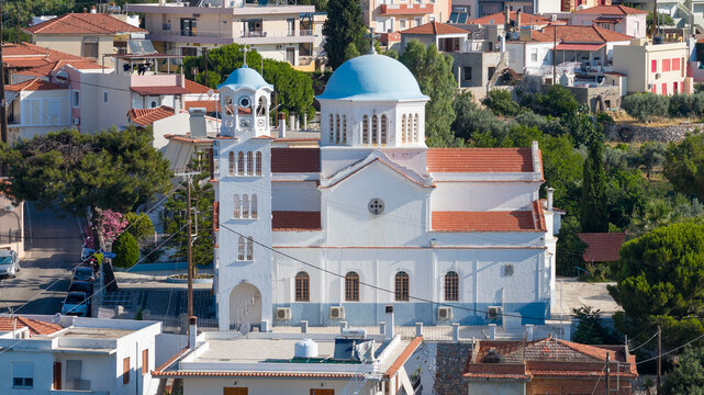 Aerial drone view of Saint Mark Church in Vrontados, Chios, Greece, surrounded by traditional houses and the Aegean Sea. Bright daylight, clear details, ideal for travel and editorial use.