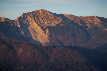 Veliki vrh in Karawanks mountain range of the Southern Limestone Alps on the border between Slovenia and Austria at sunset. Mountain range and sustainable hiking context background.