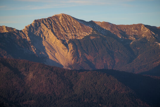 Veliki vrh in Karawanks mountain range of the Southern Limestone Alps on the border between Slovenia and Austria at sunset. Mountain range and sustainable hiking context background.