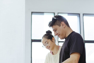 Young art students collaborating indoors, sharing ideas, learning, and creating together in a bright, modern studio