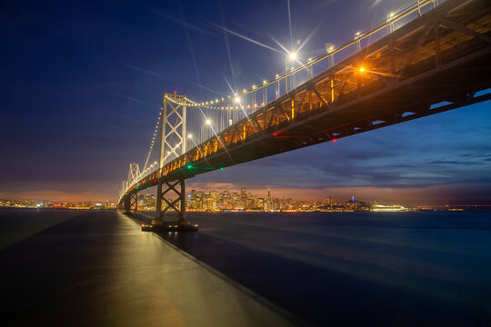 an Francisco at Dusk: Glowing Skyline and Oakland Bay Bridge from Yerba Buena Island - Powered by Adobe