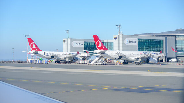 Turkish Airlines planes parked at Elliott Trudeau International Airport, showcasing modern aviation architecture and vibrant branding with clear blue sky backdrop