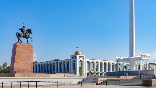 Statue of hero Manas at Ala Too Square, surrounded by modern architecture and clear blue sky, symbolizing Kyrgyz culture and history