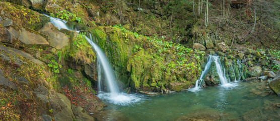 panoramic view to two cascades of waterfall in forest © sergejson