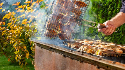 Grilling meat on barbecue with smoke rising, showcasing delicious food preparation in a vibrant...