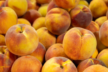 Fresh peaches on display. Organic peaches with vibrant color. Summer fresh peaches.