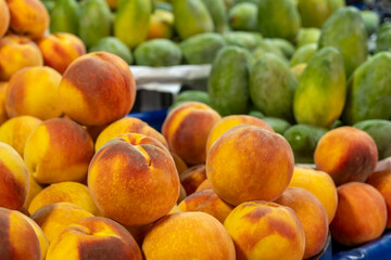 Fresh peaches on display. Organic peaches with vibrant color. Summer fresh peaches.