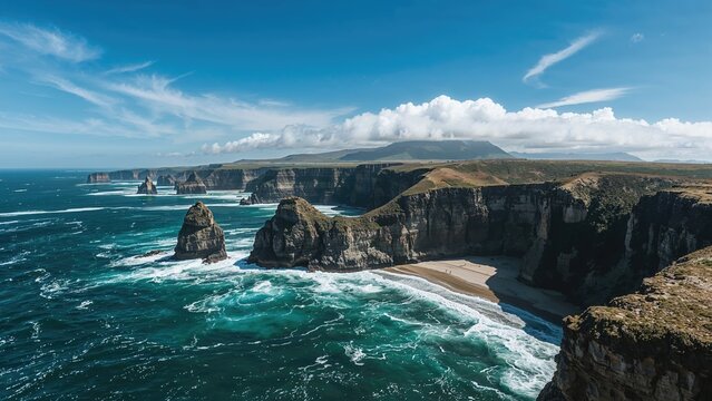 Cliffs and rock formations along the coastline with waves crashing below, under a blue sky with clouds. Coastal landscape and sea view. - Powered by Adobe