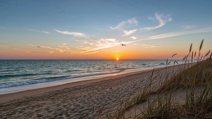 A serene ocean scene at sunset from a beach with grasses in the foreground and a colorful sky. Nature and landscape photography. The beauty of coastal environments.