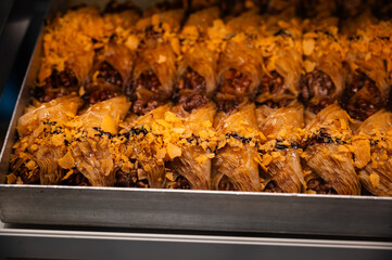 Traditional Albanian layered pastry displayed in a bakery showcase.