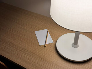 Modern Desk Lamp Illuminating Workspace with Pencil and Clean Sheets Paper