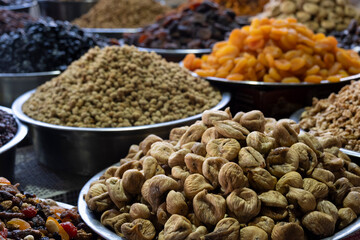 Dried Fruits Displayed at Local Market Stall. Assorted Dried Fruits for Sale at Farmers Market. Traditional Market Stall Selling Mixed Dried Fruits.