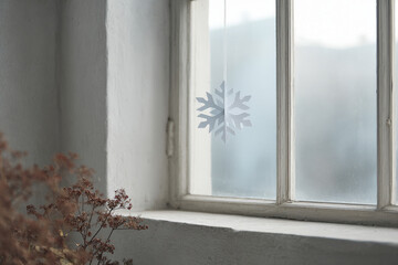 delicate paper snowflake clings to frosty window beautifully designed in minimalist style